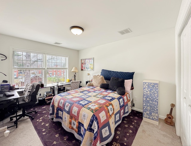 carpeted bedroom with baseboards and visible vents