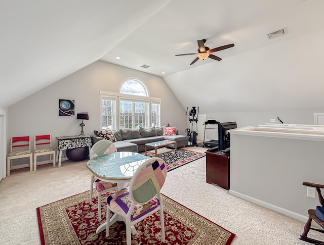 interior space with vaulted ceiling, a ceiling fan, visible vents, and carpet
