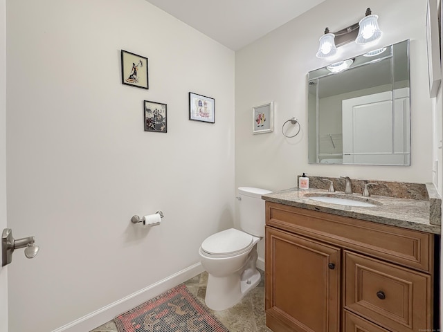 bathroom with tile patterned flooring, baseboards, toilet, and vanity