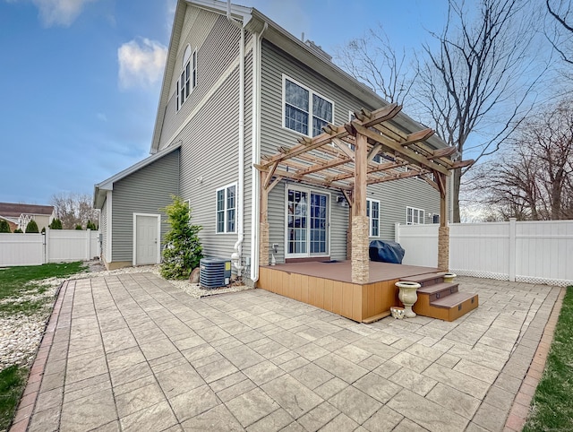 rear view of property with a fenced backyard, a pergola, central air condition unit, and a patio