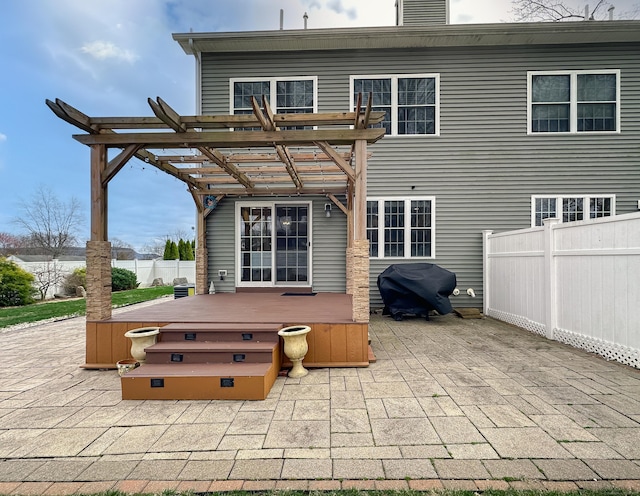 rear view of property with a pergola, a patio, fence, and a jacuzzi