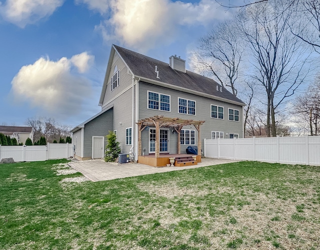 back of property with a pergola, a fenced backyard, a yard, a patio, and a hot tub