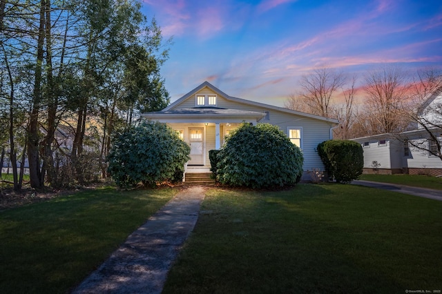 view of front of property with a front lawn and covered porch