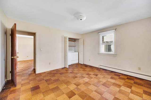 unfurnished bedroom featuring washer / clothes dryer, a baseboard radiator, and baseboards