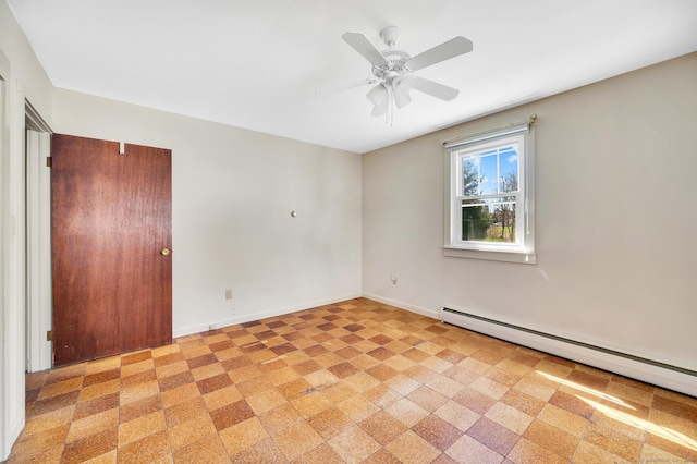 spare room featuring baseboard heating, baseboards, and ceiling fan