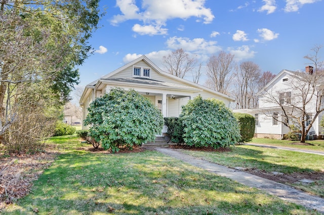 view of front of home with a front yard and covered porch