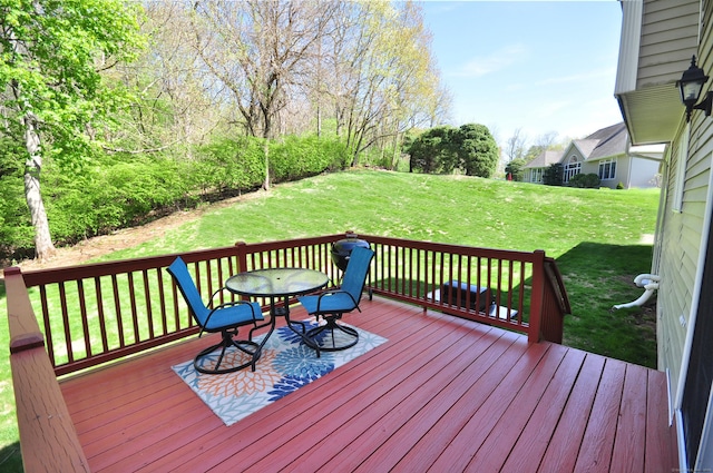 wooden terrace featuring a yard