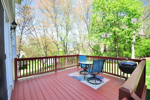 wooden terrace with grilling area and outdoor dining area