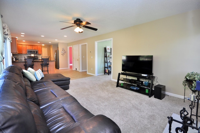 living area with recessed lighting, ceiling fan, light colored carpet, and baseboards