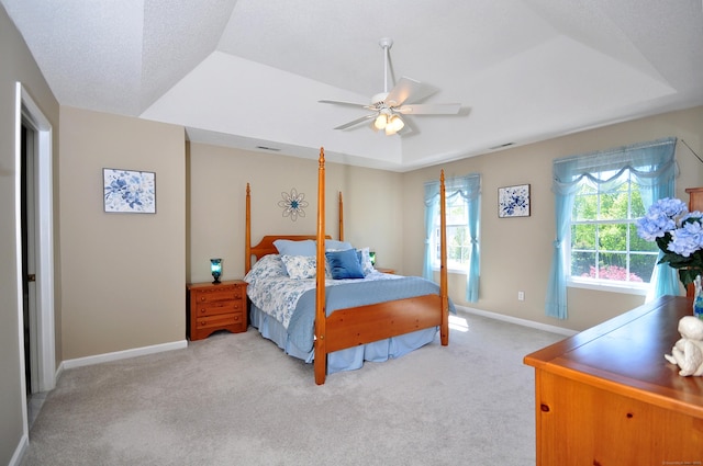 bedroom featuring baseboards, light colored carpet, and ceiling fan