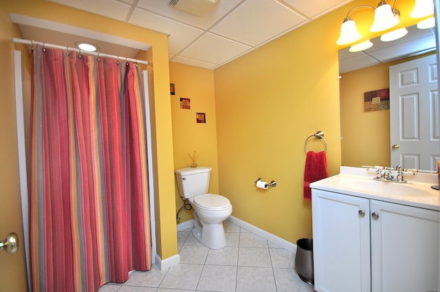 bathroom with vanity, toilet, a shower with shower curtain, a paneled ceiling, and tile patterned floors