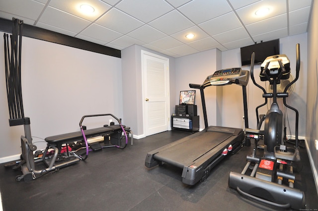 exercise area with baseboards, recessed lighting, and a paneled ceiling