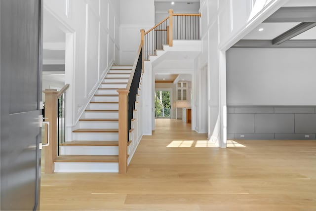 11 Tierney Ln, Westport, CT 06880 - stairs featuring a decorative wall, wood finished floors, and a high ceiling