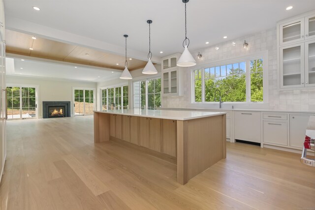 11 Tierney Ln, Westport, CT 06880 - kitchen featuring light wood-style flooring, tasteful backsplash, a large island, plenty of natural light, and recessed lighting