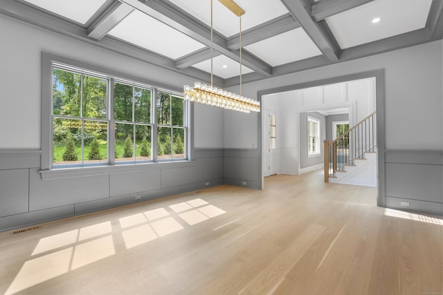 11 Tierney Ln, Westport, CT 06880 - spare room featuring coffered ceiling, healthy amount of natural light, beam ceiling, a decorative wall, and light wood-type flooring