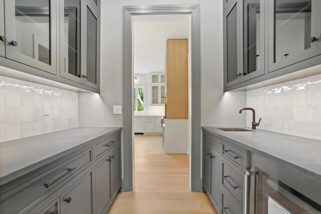 11 Tierney Ln, Westport, CT 06880 - bar area with a sink, tasteful backsplash, wine cooler, and light wood-type flooring