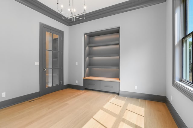 11 Tierney Ln, Westport, CT 06880 - unfurnished room featuring a chandelier, light wood-style flooring, baseboards, and built in features