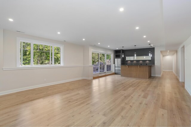 11 Tierney Ln, Westport, CT 06880 - unfurnished living room with light wood finished floors, recessed lighting, and baseboards