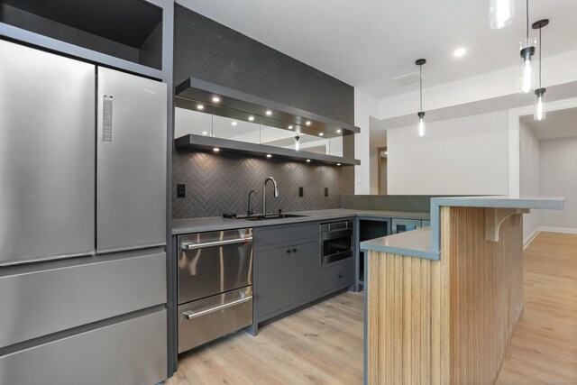 11 Tierney Ln, Westport, CT 06880 - kitchen with a sink, light wood-style floors, decorative backsplash, a breakfast bar area, and recessed lighting
