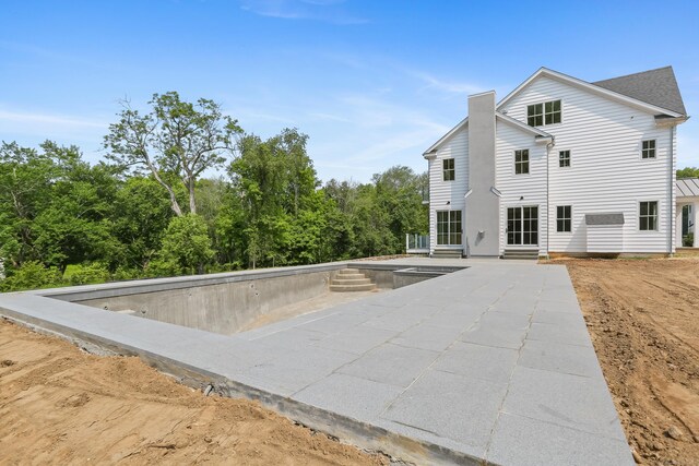11 Tierney Ln, Westport, CT 06880 - rear view of property featuring a chimney and a patio