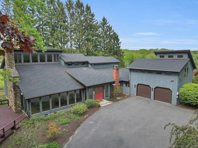 89 E St, Morris, CT 06763 - view of front facade featuring a shingled roof, an attached garage, driveway, and a chimney