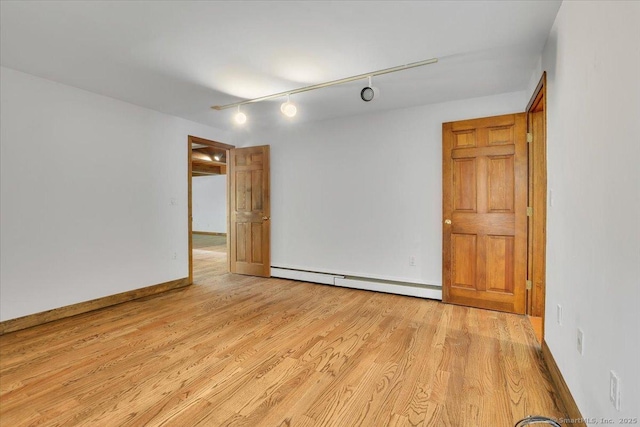 89 E St, Morris, CT 06763 - empty room featuring a baseboard heating unit, light wood-type flooring, track lighting, and baseboards