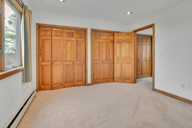 89 E St, Morris, CT 06763 - unfurnished bedroom with a baseboard heating unit, multiple closets, light colored carpet, recessed lighting, and baseboards