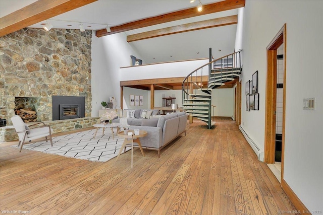 89 E St, Morris, CT 06763 - living room with baseboard heating, beam ceiling, wood-type flooring, rail lighting, and a fireplace