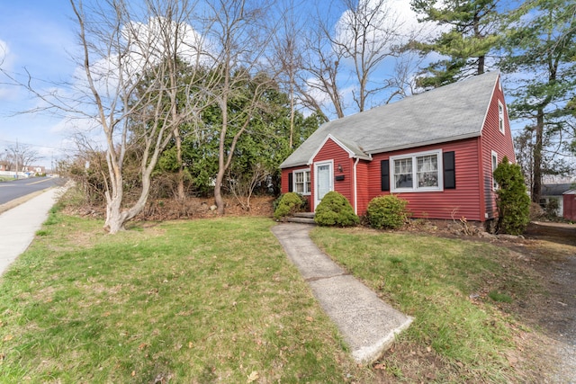 bungalow-style house with roof with shingles and a front yard