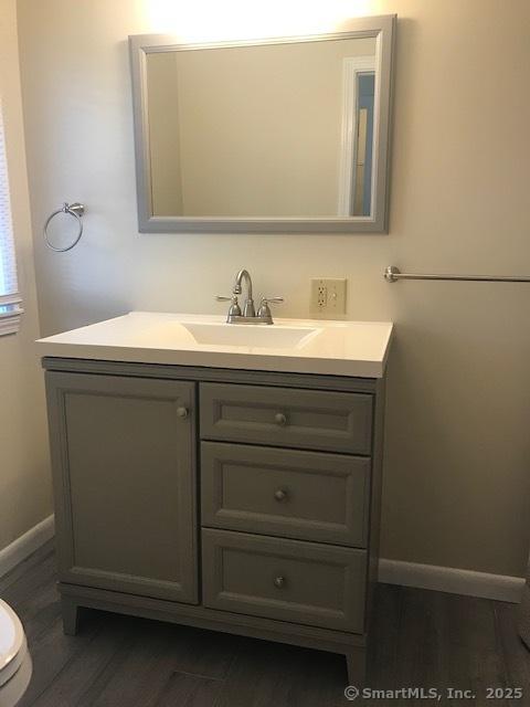 14 Court St, West Haven, CT 06516 - bathroom featuring toilet, wood finished floors, vanity, and baseboards