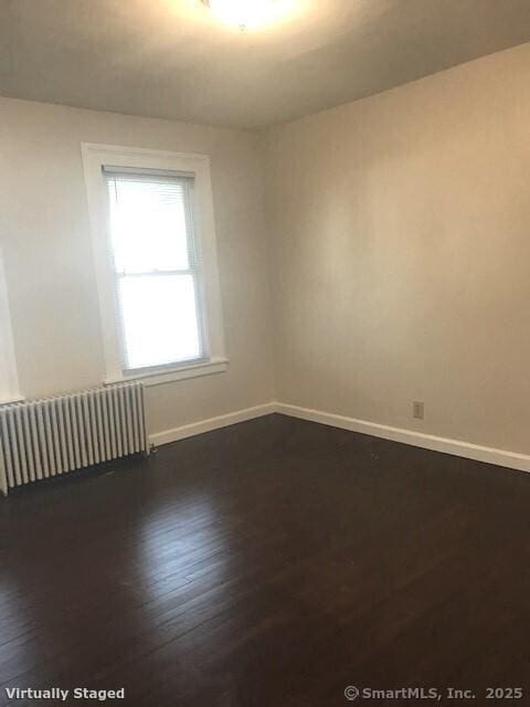 14 Court St, West Haven, CT 06516 - unfurnished room featuring dark wood-style flooring, baseboards, and radiator