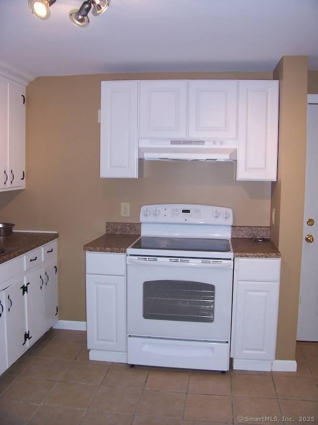 14 Court St, West Haven, CT 06516 - kitchen featuring white cabinets, under cabinet range hood, light tile patterned flooring, white range with electric stovetop, and dark countertops