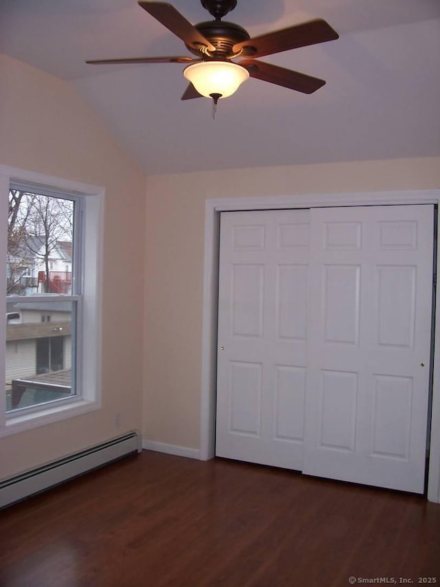 14 Court St, West Haven, CT 06516 - unfurnished bedroom featuring a closet, dark wood finished floors, vaulted ceiling, and baseboard heating