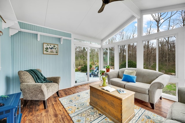 sunroom with lofted ceiling with beams and wood finished floors
