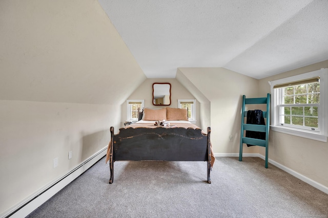 carpeted bedroom with baseboard heating, baseboards, a textured ceiling, and vaulted ceiling