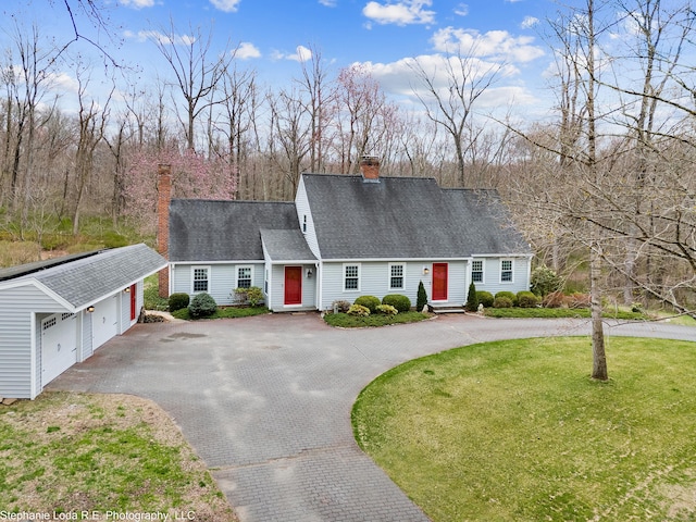 26 Old Kentwood Rd, East Haddam, CT 06423 - view of front of property with a chimney, an outdoor structure, a detached garage, a front lawn, and driveway
