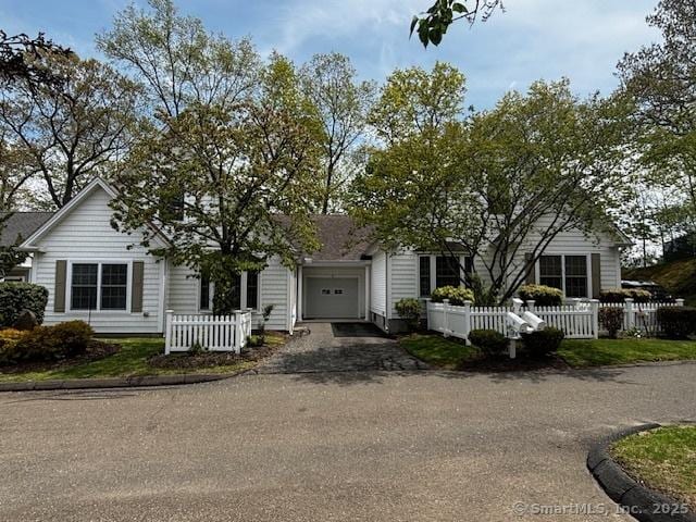 70 Allison Way Unit 70, East Haven, CT 06512 - obstructed view of property with asphalt driveway, a garage, and a fenced front yard