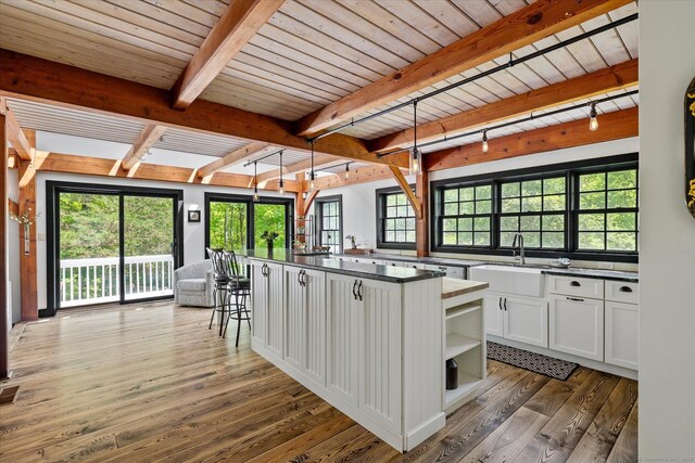128 Spaulding Rd, Brooklyn, CT 06234 - kitchen with a sink, dark countertops, hardwood / wood-style flooring, white cabinetry, and open shelves