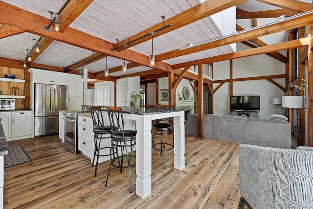 128 Spaulding Rd, Brooklyn, CT 06234 - kitchen featuring high quality appliances, light wood-type flooring, beam ceiling, white cabinetry, and a kitchen breakfast bar