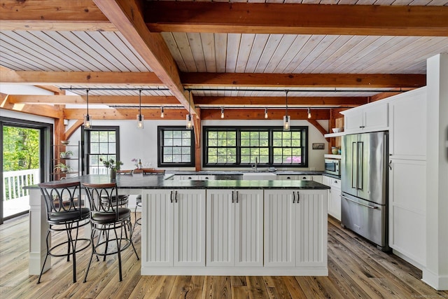 128 Spaulding Rd, Brooklyn, CT 06234 - kitchen with stainless steel appliances, dark countertops, white cabinetry, plenty of natural light, and beam ceiling