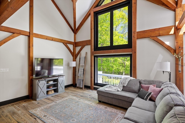 128 Spaulding Rd, Brooklyn, CT 06234 - living area featuring wood finished floors, beam ceiling, high vaulted ceiling, and baseboards