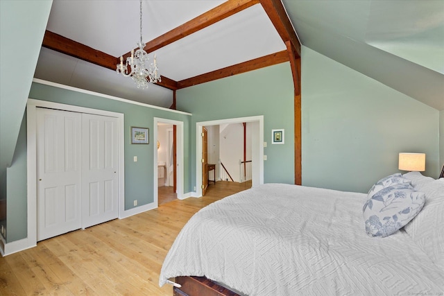 128 Spaulding Rd, Brooklyn, CT 06234 - bedroom featuring a chandelier, wood finished floors, baseboards, a closet, and connected bathroom