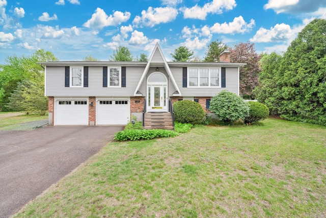340 Brookfield St, South Windsor, CT 06074 - raised ranch featuring brick siding, driveway, a front yard, and a chimney