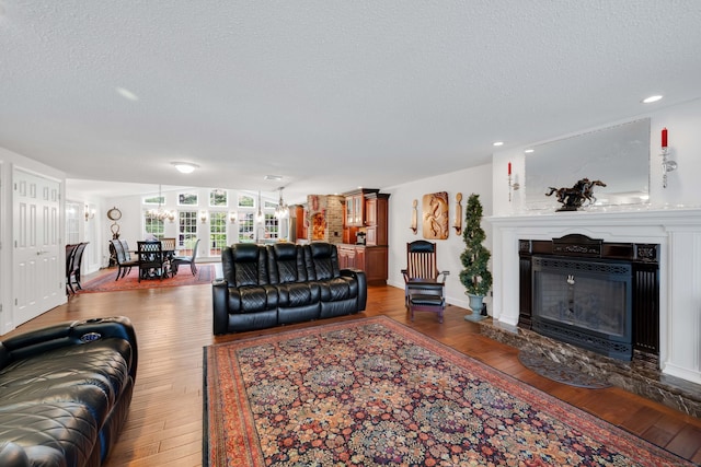 340 Brookfield St, South Windsor, CT 06074 - living area featuring a textured ceiling, hardwood / wood-style floors, a glass covered fireplace, and recessed lighting
