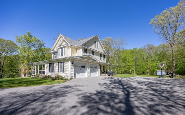 31 Cambridge Ct, Colchester, CT 06415 - view of property exterior with asphalt driveway, an attached garage, and a yard