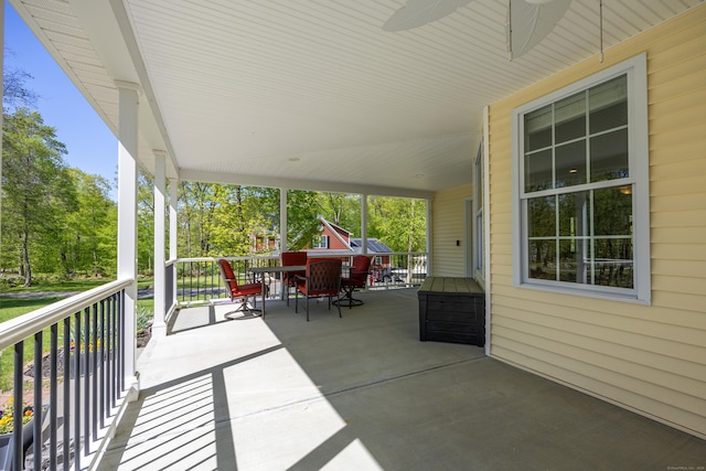 31 Cambridge Ct, Colchester, CT 06415 - view of patio featuring outdoor dining area, a porch, an attached carport, view of scattered trees, and ceiling fan