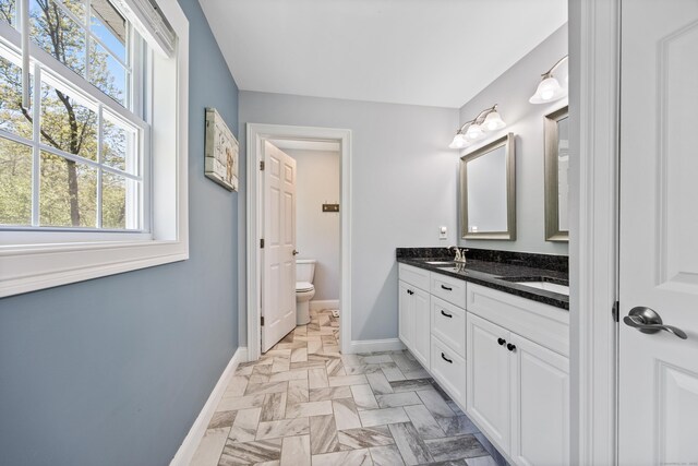 31 Cambridge Ct, Colchester, CT 06415 - bathroom with baseboards, healthy amount of natural light, toilet, and double vanity