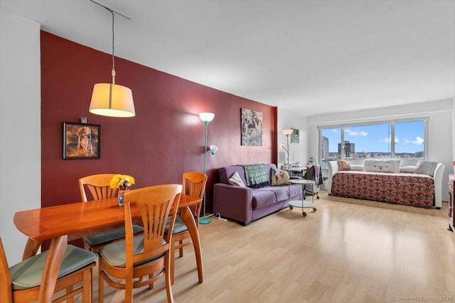 dining space with a city view and wood finished floors