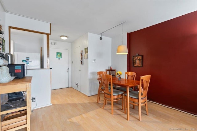 dining space featuring light wood-style flooring