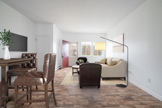 living area with wood finished floors and baseboard heating